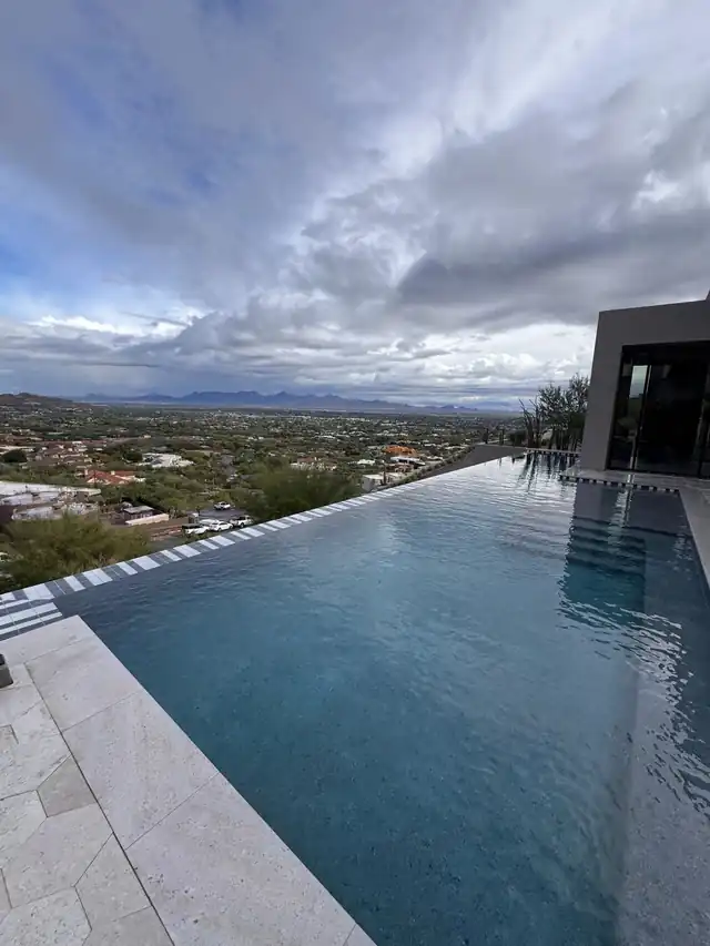 Infinity edge under storm clouds with the valley below